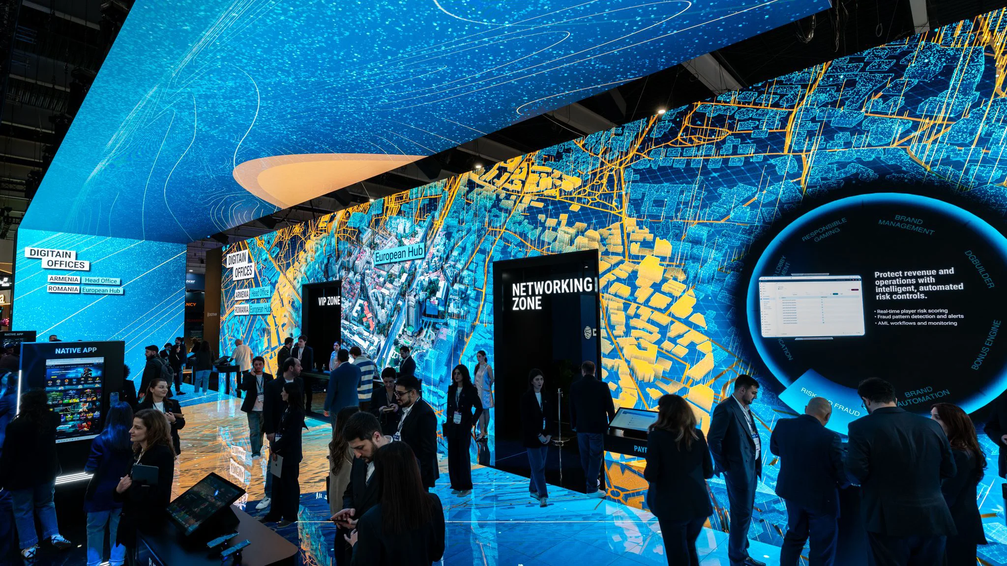 Inside the Digitain stand with immersive LED ceiling and map graphics, attendees walking past the Networking Zone entrance.