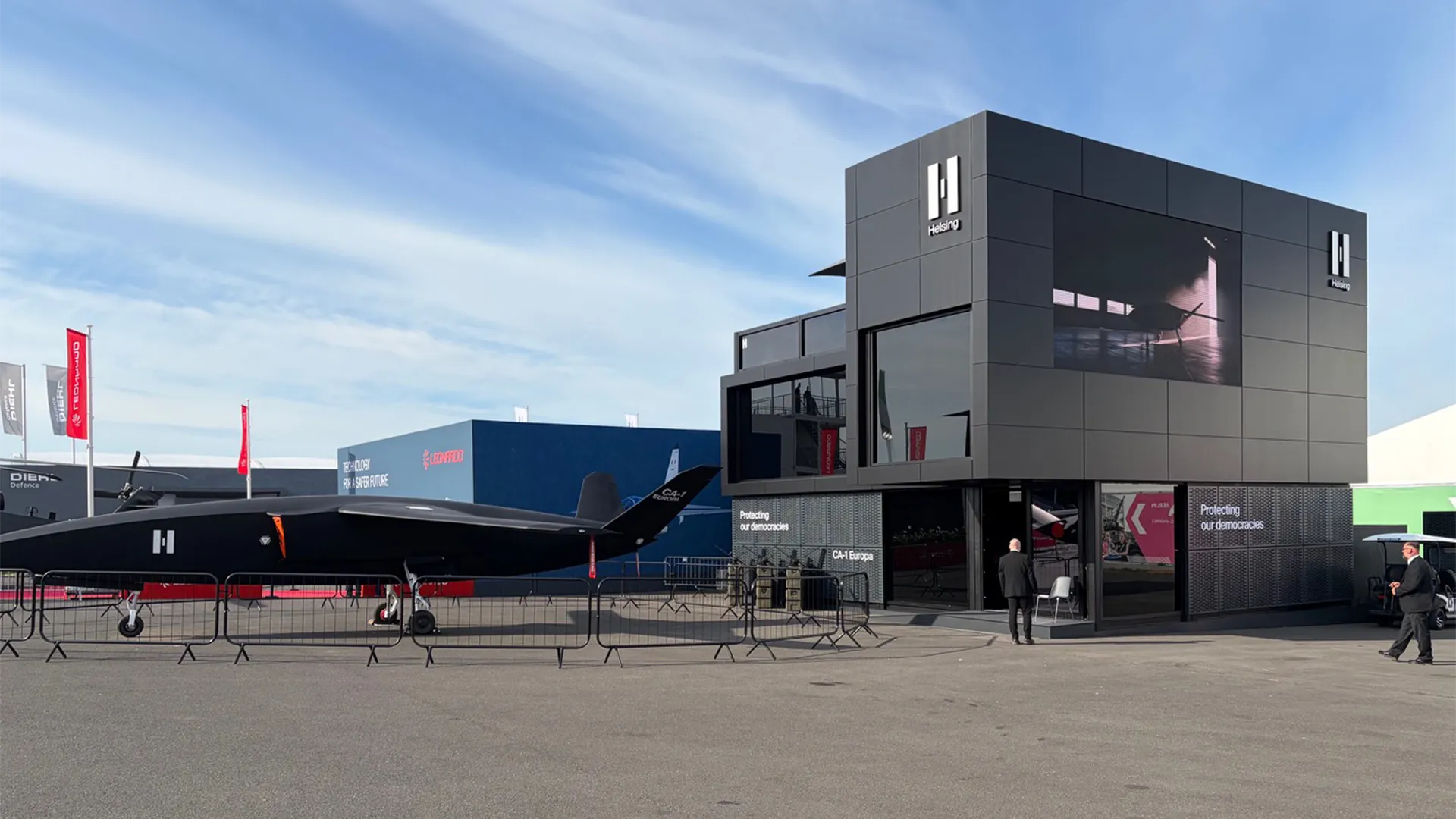 Exterior of Helsing’s two-storey chalet beside the CA-1 Europa aircraft at ILA Berlin 2026