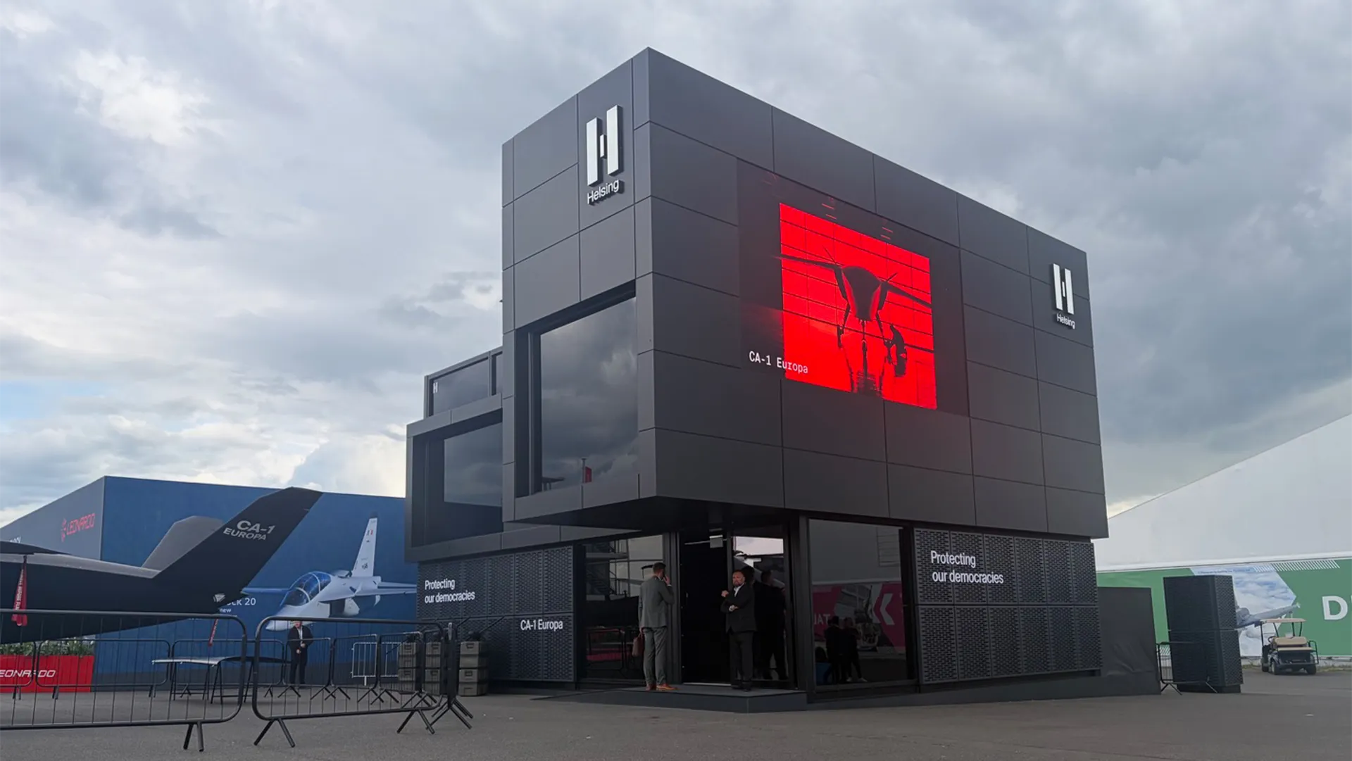 Helsing’s chalet at ILA Berlin 2026 with a red CA-1 Europa display screen and aircraft positioned alongside